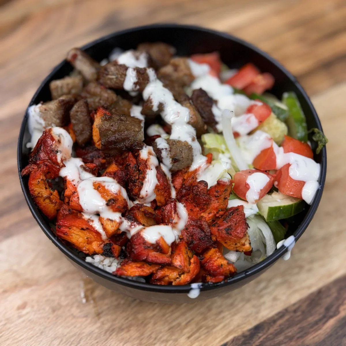 Combo Platter with grilled lamb, chicken kebab pieces, fresh vegetables and sauce, 100% halal cooked to order