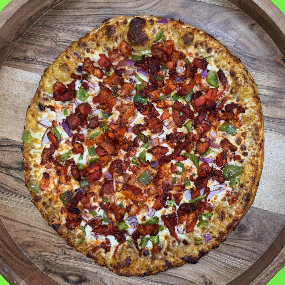 Butter Chicken Pizza with spiced chicken, onions and peppers, 100% halal, cooked to order on Valley Street, Providence